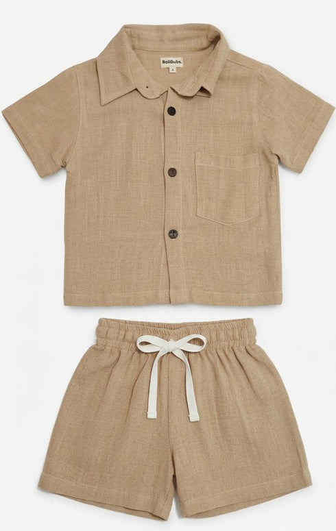 Children's beige shirt and shorts set on a white background