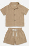 Children's beige shirt and shorts set on a white background