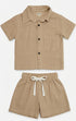 Children's beige shirt and shorts set on a white background