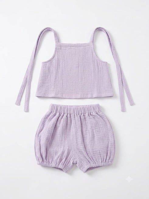 A two-piece baby outfit set in light purple/lavender textured cotton gauze, featuring a sleeveless tie-strap crop top and matching elastic-waist bubble shorts