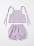 A two-piece baby outfit set in light purple/lavender textured cotton gauze, featuring a sleeveless tie-strap crop top and matching elastic-waist bubble shorts