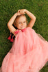 pink tulle dress with white polka dots and a bow at the neckline.