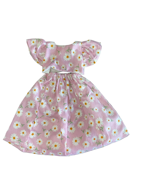 Pink floral dress on a white surface