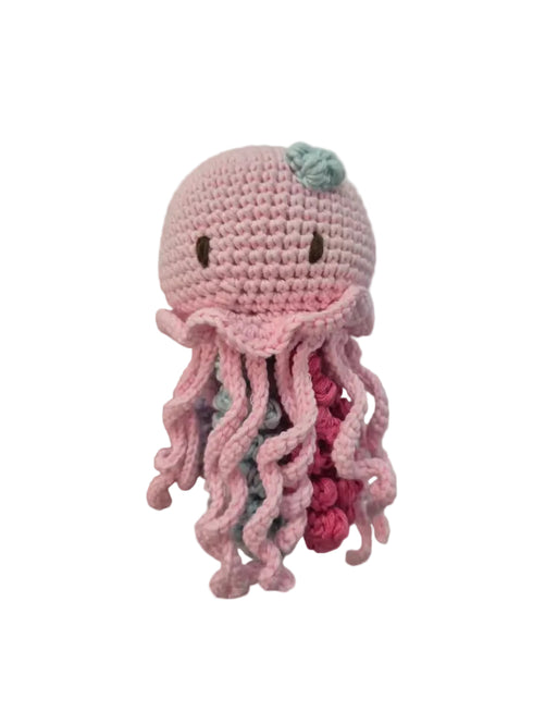 A crocheted plush octopus toy in light pink yarn with darker pink tentacles, small dark embroidered eyes, and a small mint green bow on top.