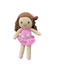 Crocheted doll with pink dress and brown hair on a white board