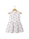 White dress with red strawberry pattern on a hanger against a white background