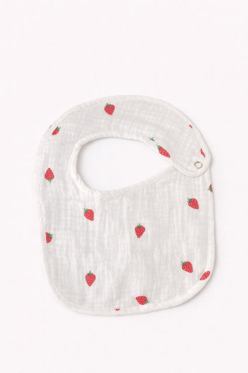 White baby bib with red strawberry pattern on a white background