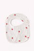 White baby bib with red strawberry pattern on a white background