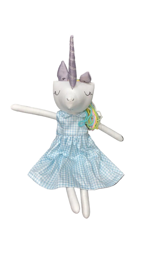 Stuffed unicorn toy with a blue dress sitting on a chair.
