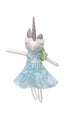 Stuffed unicorn toy with a blue dress sitting on a chair.