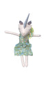 Unicorn-shaped plush toy with a floral dress on a chair