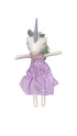 Plush toy with a unicorn horn and pink checkered dress on a dark surface