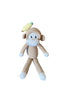 Crocheted monkey toy with a banana on a wooden surface