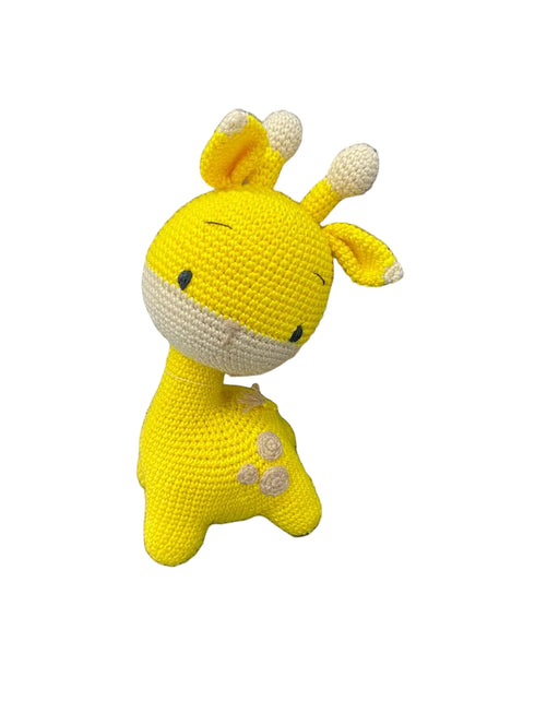 Yellow crochet giraffe toy on a white background