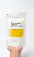 Hand holding a package of CG Dough with a visible label on a white background