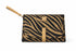 Clutch bag with zebra pattern and gold accents on a white background